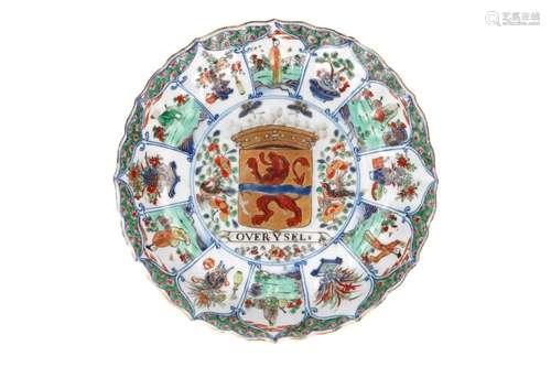 A polychrome porcelain lobed armorial dish with scalloped ri...