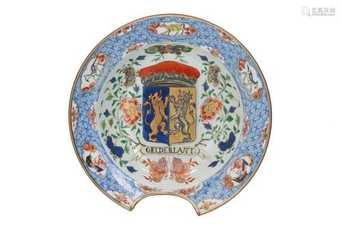 A polychrome porcelain armorial shaving basin, decorated wit...