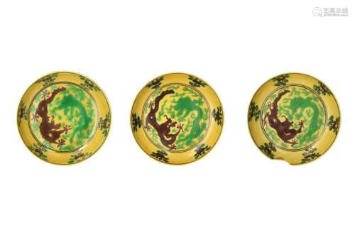 A set of three yellow ground porcelain deep saucers, with gr...