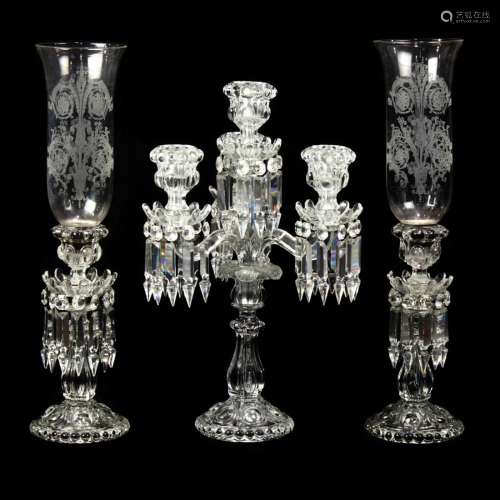 A Baccarat molded glass assembled candle garniture in the Me...