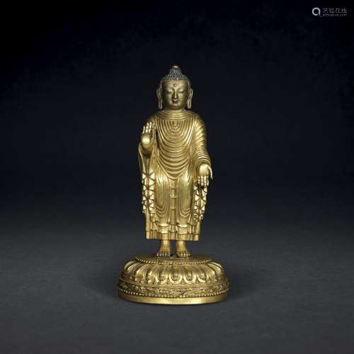 A VERY RARE EARLY-MING GILT-BRONZE STANDING FIGURE OF MAITRE...