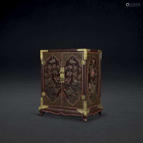 AN INCISED AND GILT POLYCHROME LACQUER CABINET