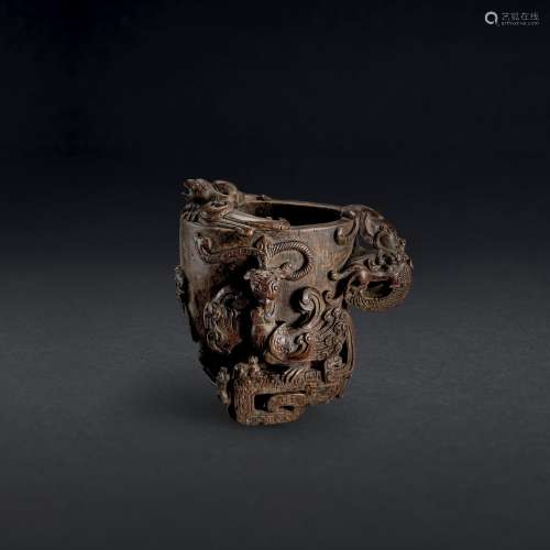 A CARVED ALOESWOOD ‘DRAGON AND PHOENIX’ LIBATION CUP