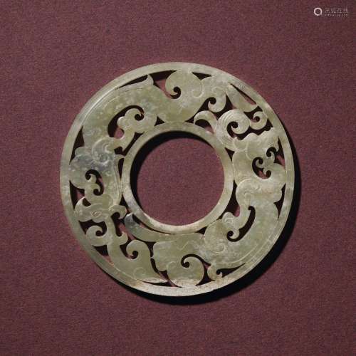 A PALE CELADON JADE RETICULATED ‘DRAGON AND PHOENIX’ DISC, B...