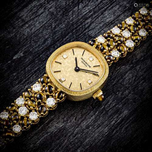 PATEK PHILIPPE. A LADY’S UNUSUAL 18K GOLD, DIAMOND AND TIGER...