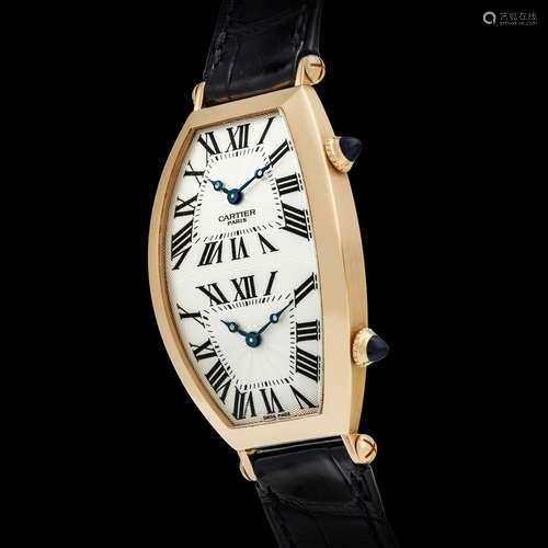 CARTIER. AN 18K PINK GOLD TONNEAU-SHAPED DUAL TIME WRISTWATC...