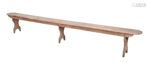 A STAINED PINE TRESTLE BENCH