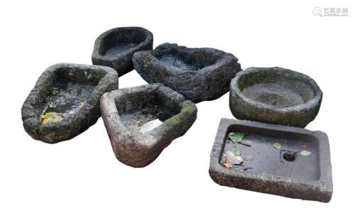 A GROUP OF SIX SHAPED STONE TROUGHS