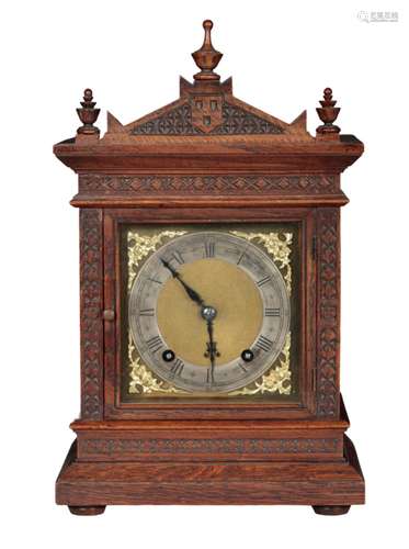 AN OAK MANTEL CLOCK