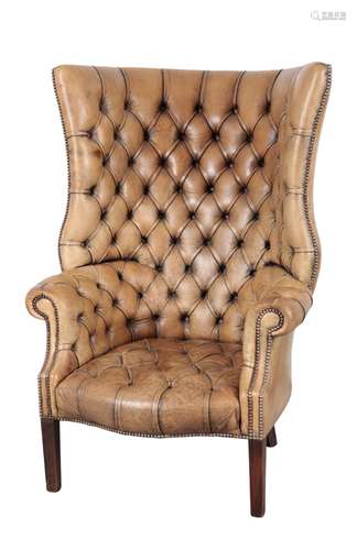 A GEORGE III STYLE BARREL BACK ARMCHAIR