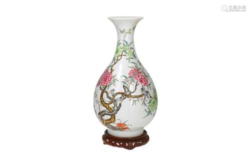 A polychrome porcelain vase on wooden base