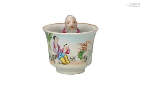 A polychrome porcelain trick cup