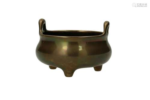 A bronze tripod censer with two handles