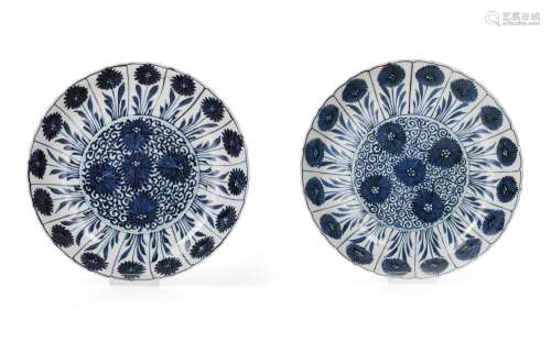 A pair of blue and white porcelain deep chargers with scallo...