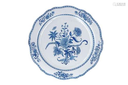 A blue and white porcelain charger with scalloped rim