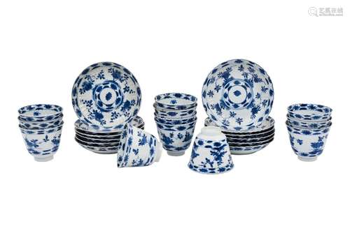 A set of 12 blue and white lobed porcelain cups with saucers...