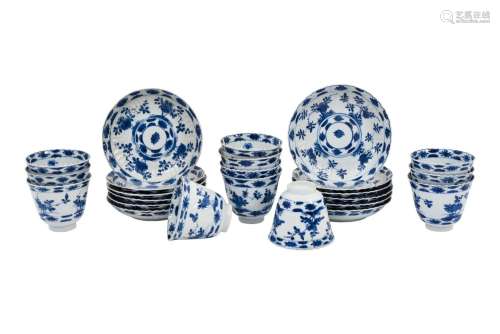A set of 12 blue and white lobed porcelain cups with saucers...