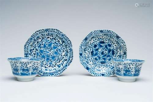 A pair of Chinese blue and white cups and saucers with flora...
