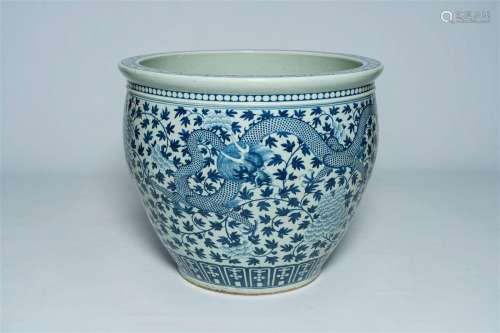 A large Chinese blue and white jardinière with a dragon and ...