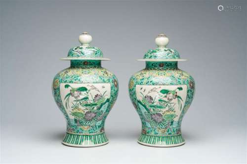 A pair of Chinese verte biscuit vases and covers with landsc...