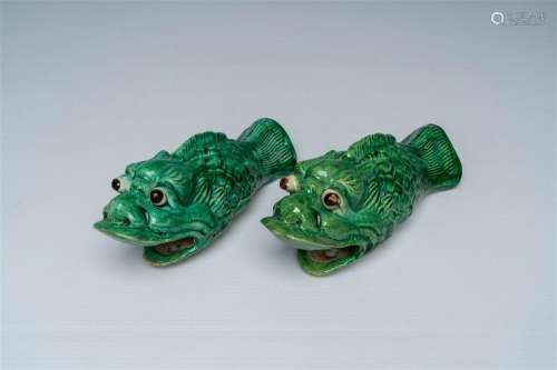 A pair of Chinese green glazed earthenware 'carp' wall vases...