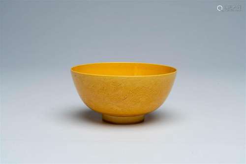 A Chinese monochrome yellow bowl with incised design of drag...