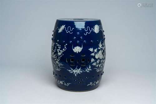 A Chinese slip-decorated blue ground garden seat with floral...