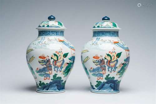 A pair of Chinese wucai vases and covers with figures in a l...