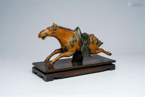 A Chinese sancai-glazed pottery 'horse' roof tile, possibly ...