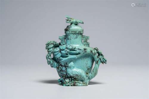 A Chinese carved turquoise vase and cover with a cat below a...