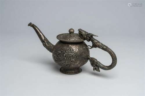 A Chinese silver teapot and cover with a dragon-shaped handl...