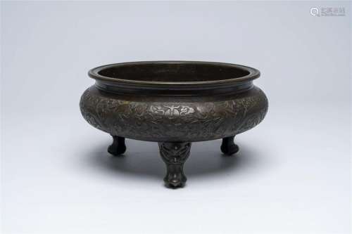 A Chinese bronze tripod 'dragons chasing the pearl' censer, ...
