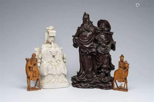 Four various Chinese wood and blanc de Chine figures, 19th/2...