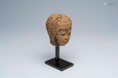 A Thai black ink-heightened pottery head of Buddha, probably...
