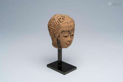 A Thai black ink-heightened pottery head of Buddha, probably...