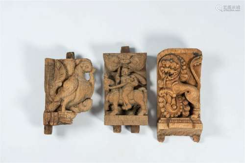 Three South-Indian carved wood reliefs with a horseman and m...