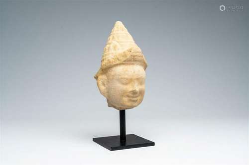 A Khmer stone head of a deity, Cambodia, Angkor Wat period, ...