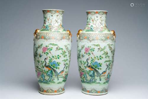 A pair of Chinese Canton famille rose vases with birds among...