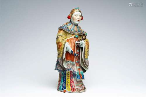 A Chinese famille rose figure of an elder holding a ruyi sce...