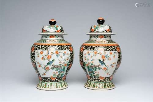 A pair of Chinese famille verte vases and covers with birds ...