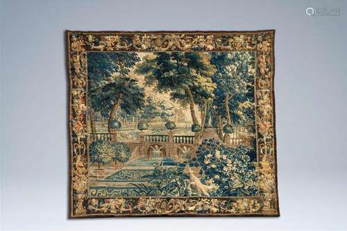 A large Flemish wall tapestry with a view on a pleasure gard...