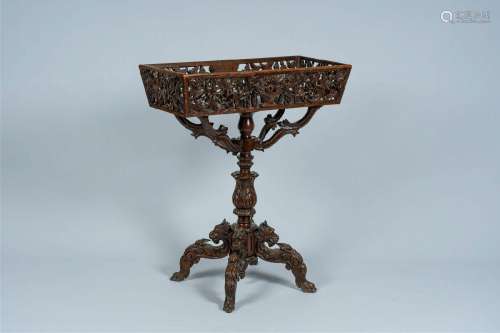 A German open worked wood jardinière on stand with dragon he...