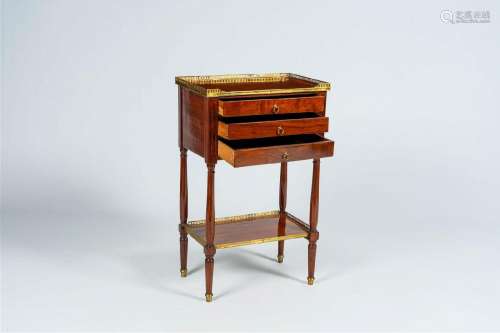 A French mahogany gilt brass mounted side table with three d...