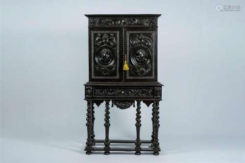 An ebonised wood two-door cabinet on stand with portrait med...