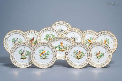 A set of eleven French plates and one oval charger with gilt...