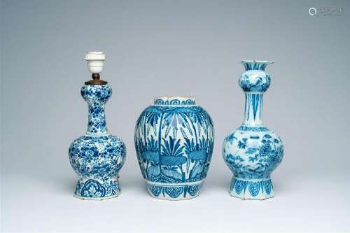 A Dutch Delft blue and white ribbed vase and two garlic-head...