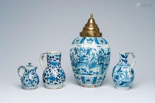 Three Dutch Delft blue and white jugs and a vase and cover w...