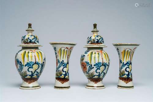 A Dutch Delft polychrome four-piece vase garniture with flor...
