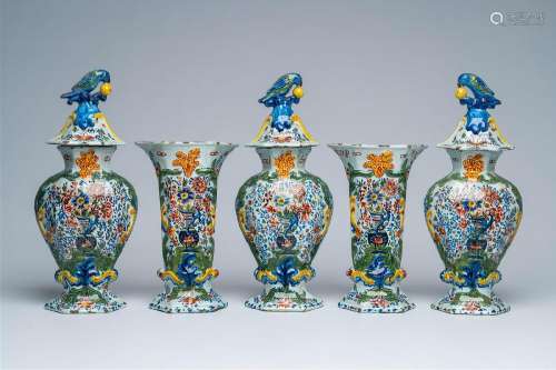 A Dutch Delft polychrome five-piece vase garniture with flor...