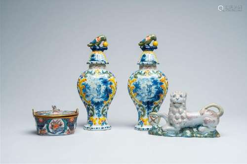 A pair of polychrome Delft vases and covers, a butter tub an...
